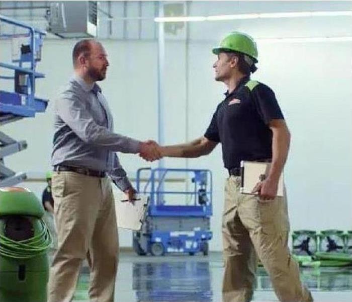man shaking another mans hand